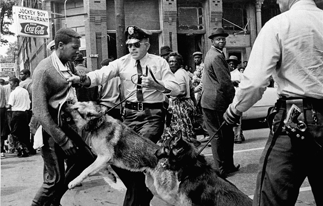 ** FILE ** A 17-year-old civil rights demonstrator, defying an anti-parade ordinance in Birmingham, Ala., is attacked by a police dog in this May 3, 1963 file photo. On the afternoon of May 4, 1963, during a meeting at the White House with members of a political group, President Kennedy discussed the photo which had appeared on the front page of that days New York Times. The John F. Kennedy Library and Museum in Boston released the tape, which was captured on the White House recording system, to coincide with Martin Luther King Day Monday. (AP Photo/Bill Hudson, File) MAMD101 (BILL HUDSON / The Associated Press)